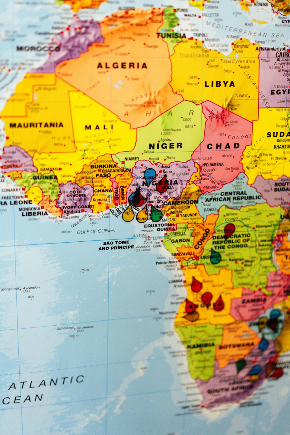 Colorful map of West Africa marked with red and blue pins.