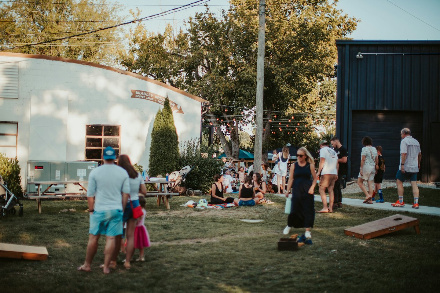 People socialize and play lawn games outside Bradley Mountain Coffee Shop.