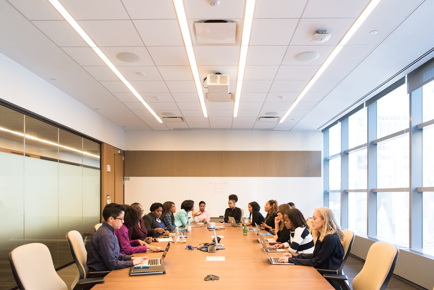 Professionals collaborating around a conference table during a meeting.